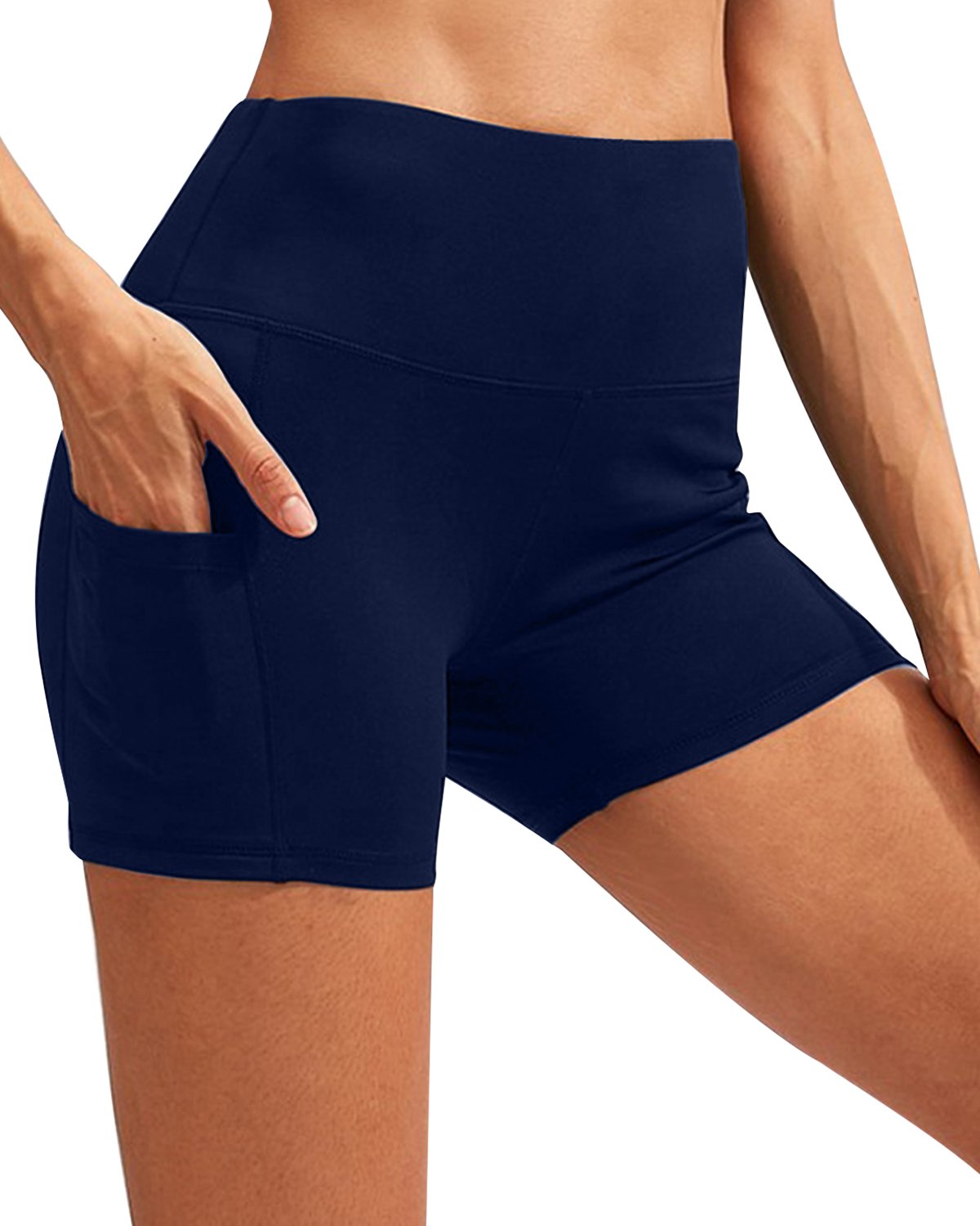 A person wearing navy Calcao High Waist Yoga Shorts With Pocket, offering compression fit and high-rise waist, paired with black shoes.
