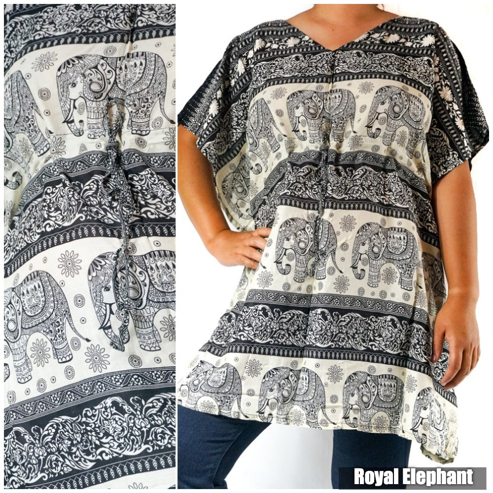 A Boho Elephant Kaftan Dress, crafted from breathable rayon, showcases a bold black tunic with white elephant and floral patterns. The wearer confidently places one hand on their hip as the brand "big elephant" subtly features in the corner.