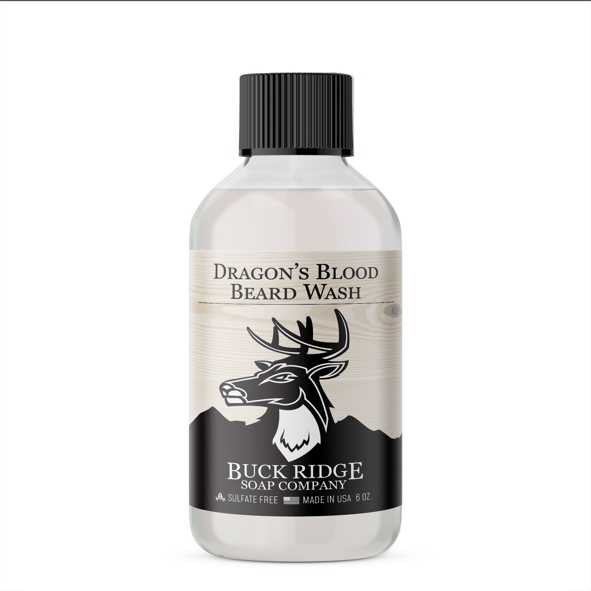 The Buck Ridge Dragon's Blood Beard Wash features a sleek design with a clear bottle, a black screw cap, and the iconic deer logo. Made in the USA, this sulfate-free, plant-based beard wash is thoughtfully crafted to refresh your grooming routine.