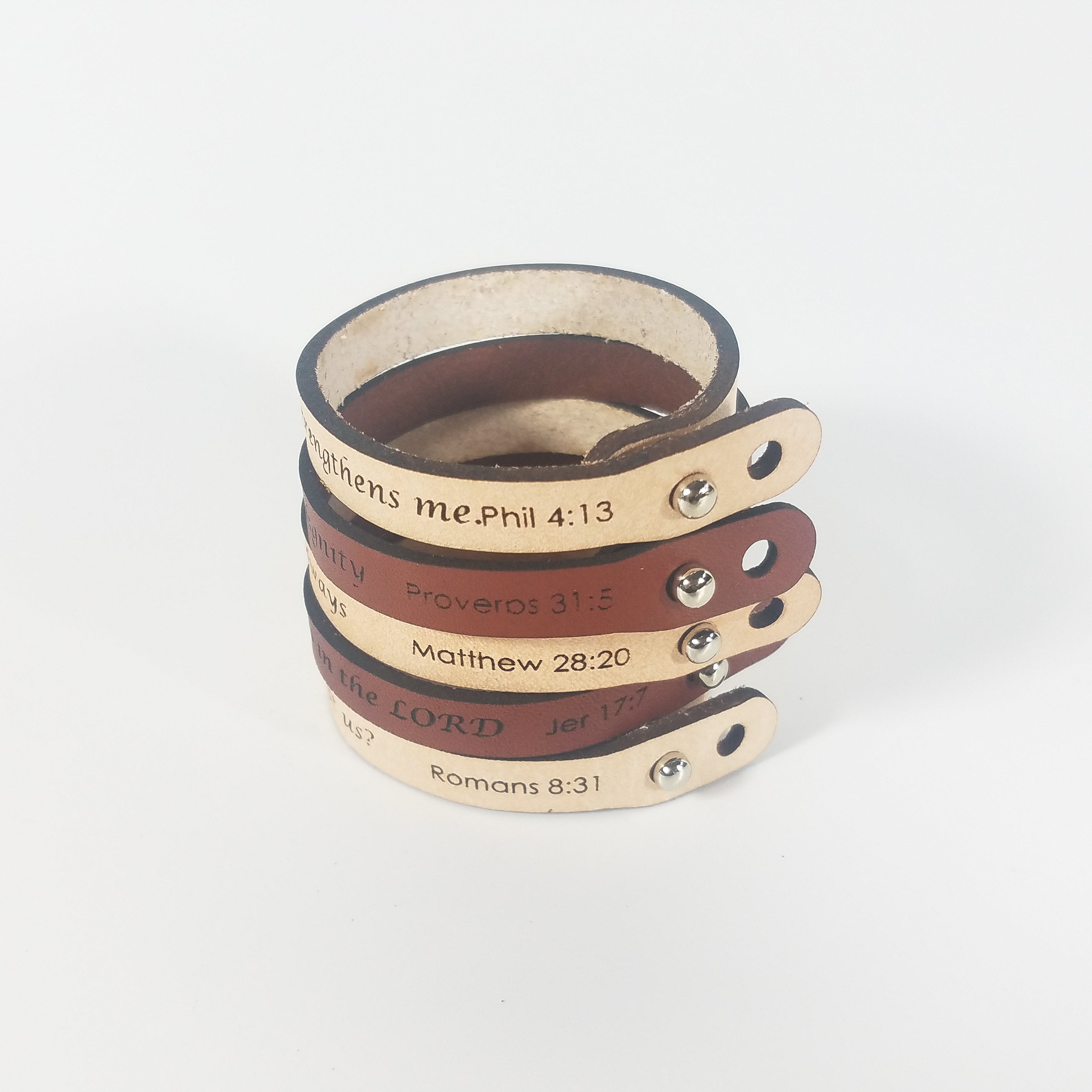 The Spiritual Quote Bracelet, made of genuine leather and featuring an adjustable button closure, skillfully blends style with motivation by showcasing the inspirational message: "I can do all things through him who strengthens me.