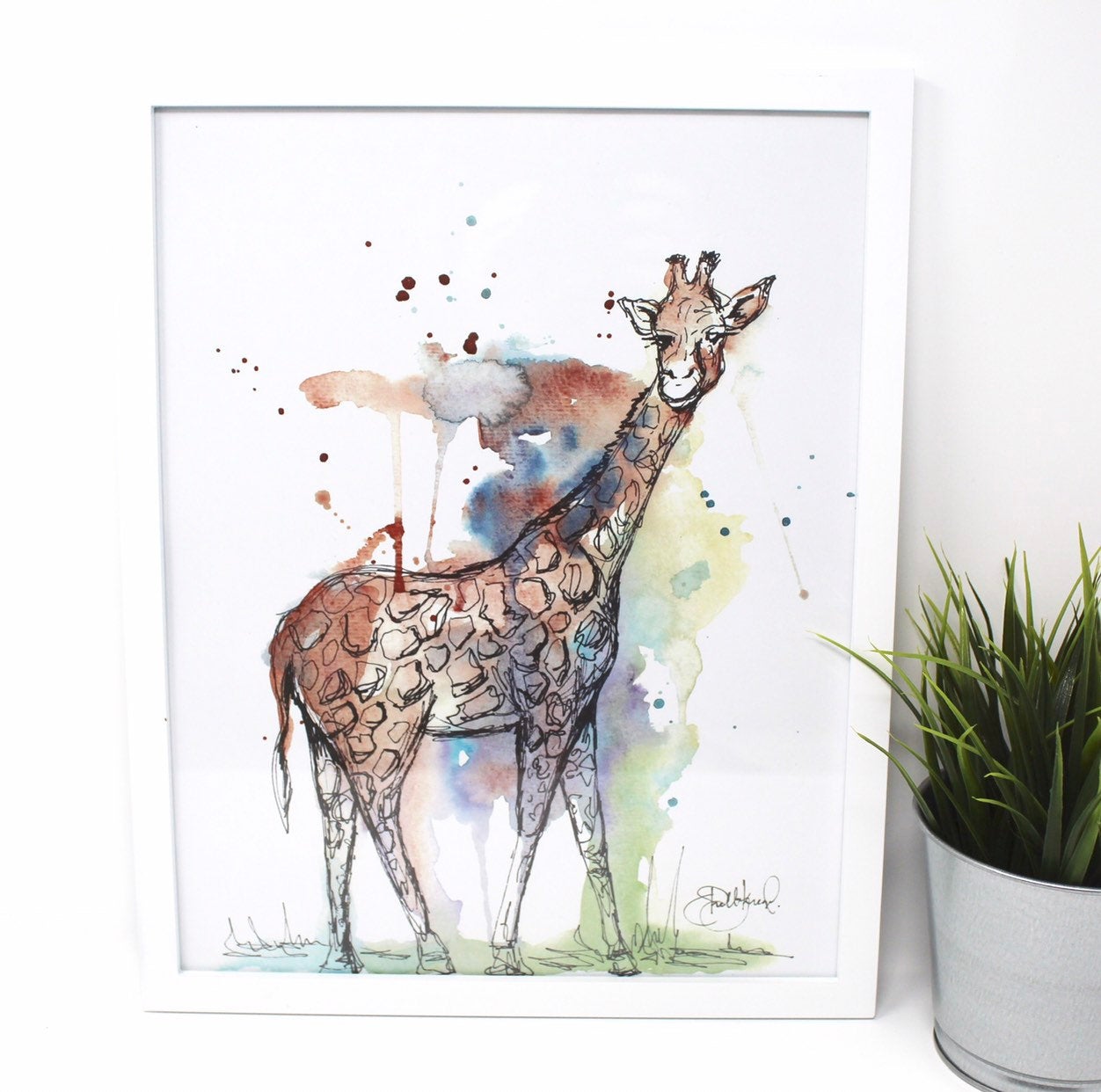 The Mixed Media Giraffe Art Print - 11x14in offers a captivating watercolor illustration of a giraffe set against a backdrop of blue, green, and brown splashes, making it a delightful addition to any nursery decor.
