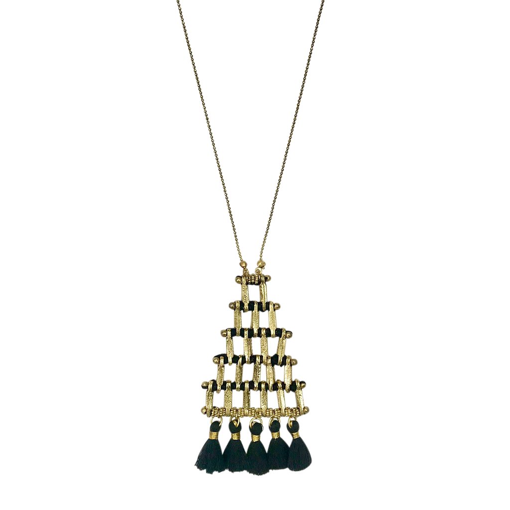 The Kai Pyramid Necklace is a gold-tone statement piece with a geometric grid design, featuring black tassels that gracefully hang at the bottom, adding an elegant touch.