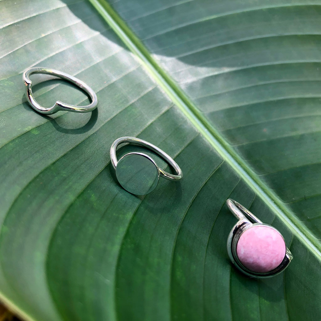 Discover the Pink Moon Ring: a sterling silver masterpiece featuring a round pink stone, beautifully set in a semi-circle bezel design.