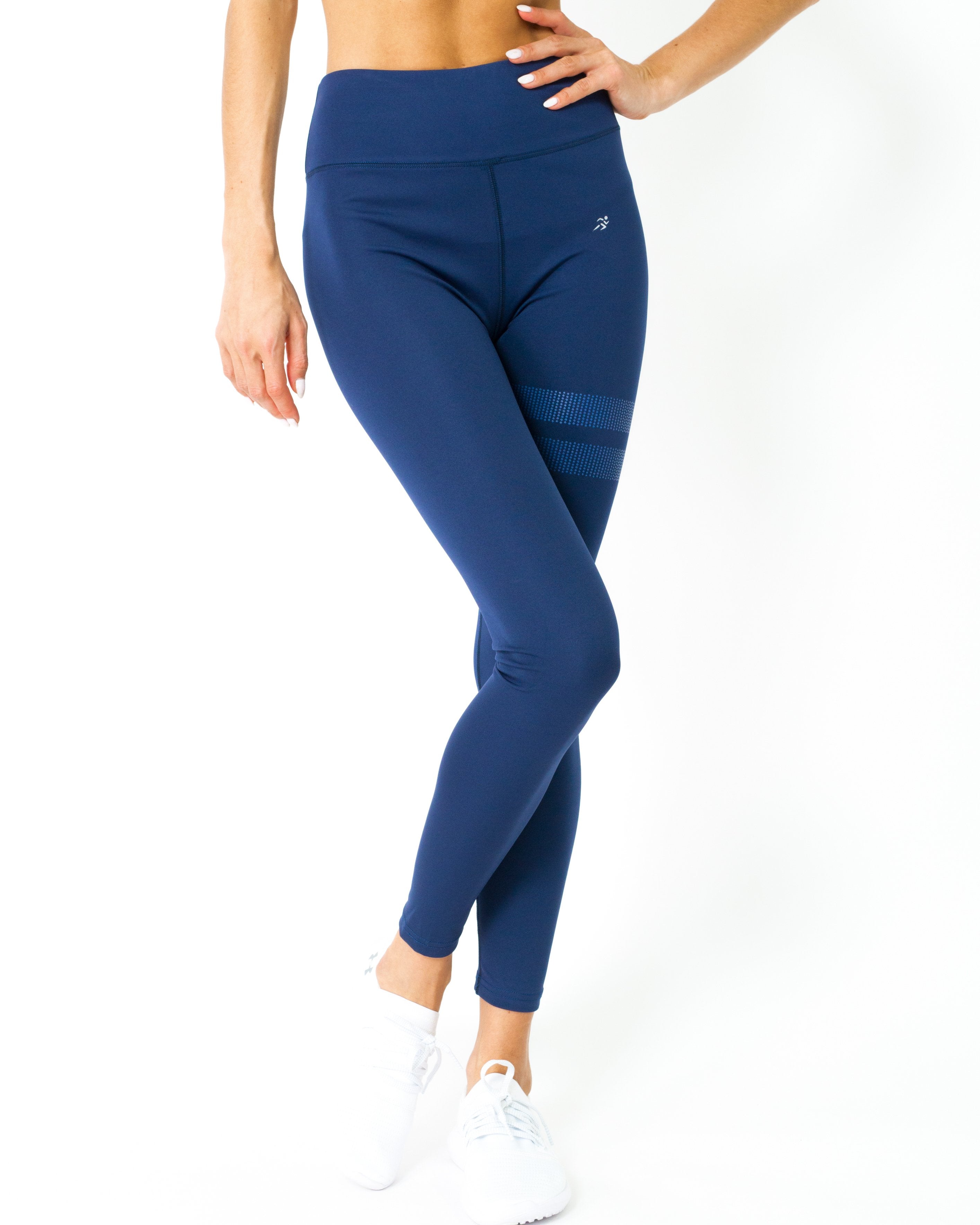 A person wearing navy blue Ashton Leggings from Savoy Active, made from Brazilian textile, showcases the sculpted compression fit in a side profile with one leg slightly forward.