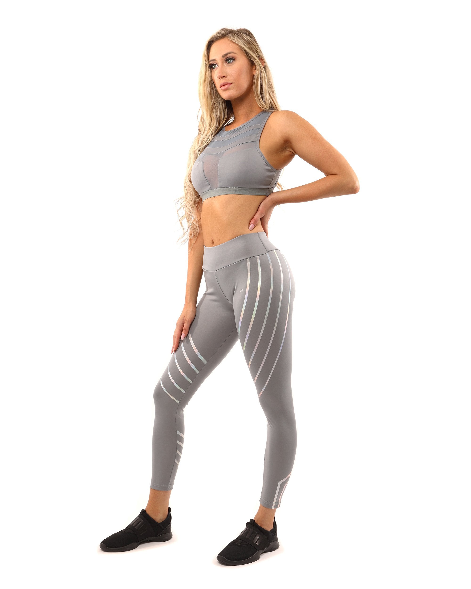 A woman wearing a Savoy Active Laguna Sports Bra in grey stands facing the camera against a white background.