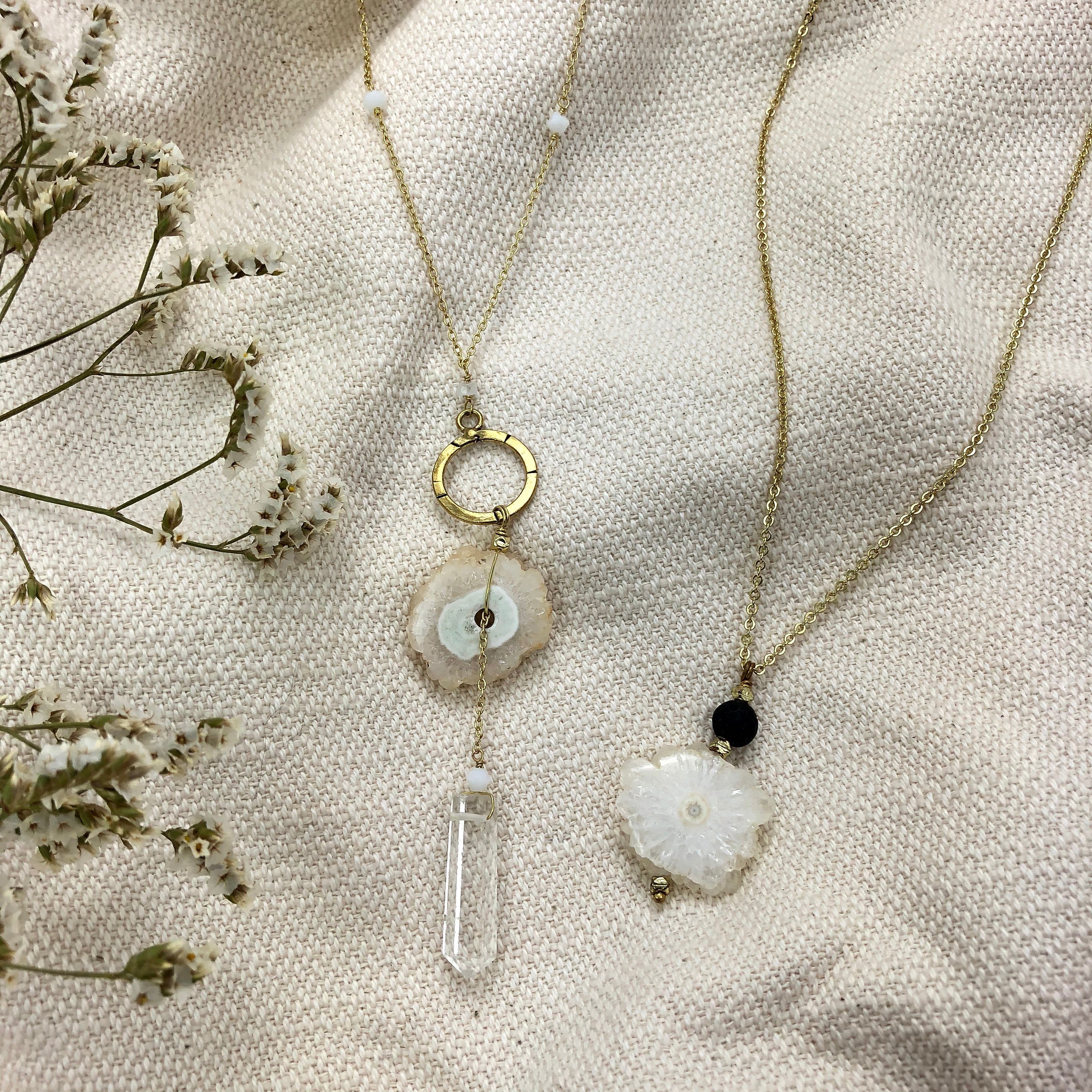The Solar Quartz + Crystal Y Necklace is an enchanting piece of handmade jewelry, featuring a gold necklace with a circular pendant and two stunning stones, including solar quartz.