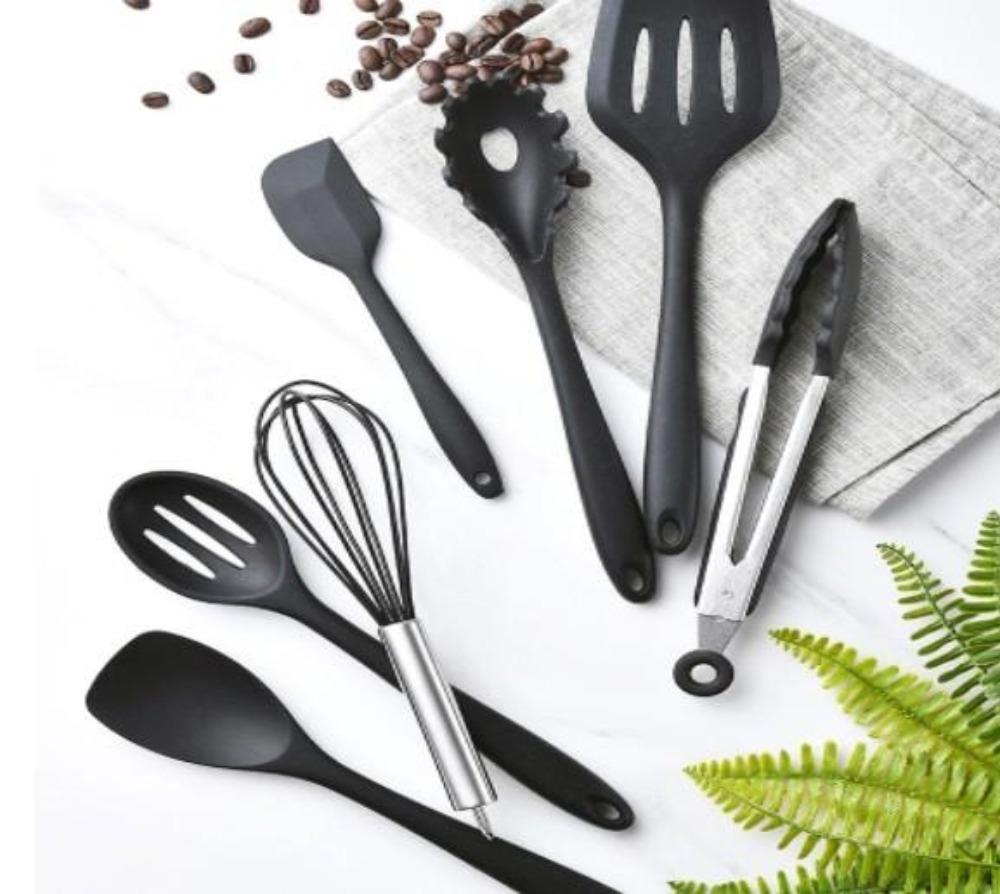 A set of Non Stick Silicone Cooking Utensils Premium Heat Resistant 10 PCS Set, including spatulas, spoons, tongs, and a whisk, arranged on a white background.