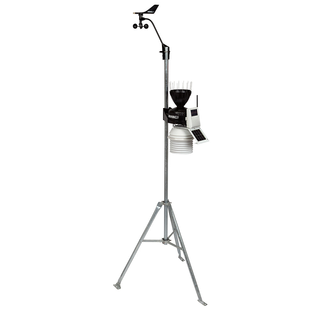 A Davis Instruments weather station on a stand with a bird on it.