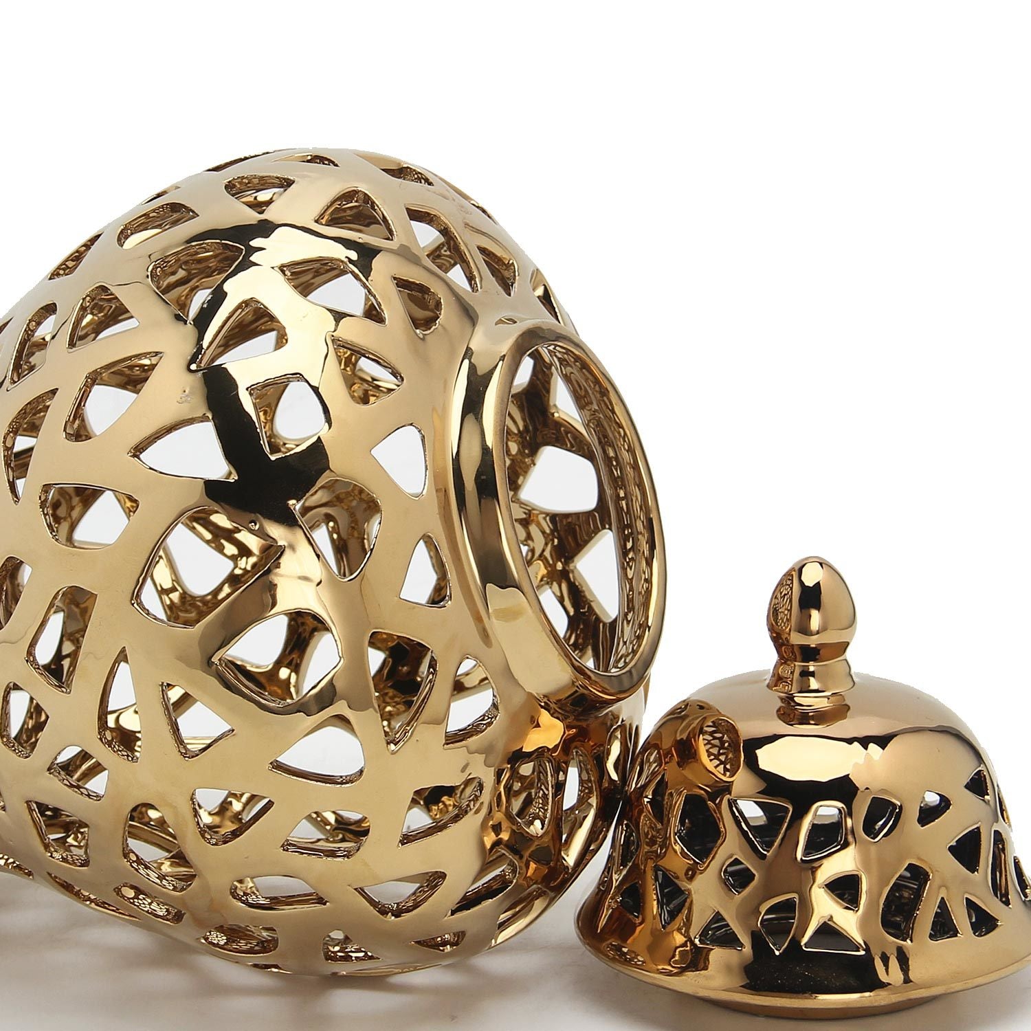 A golden, intricately pierced Gold Ceramic Ginger Jar Vase with Decorative Design with a removable lid, isolated on a white background, perfect for interior design.