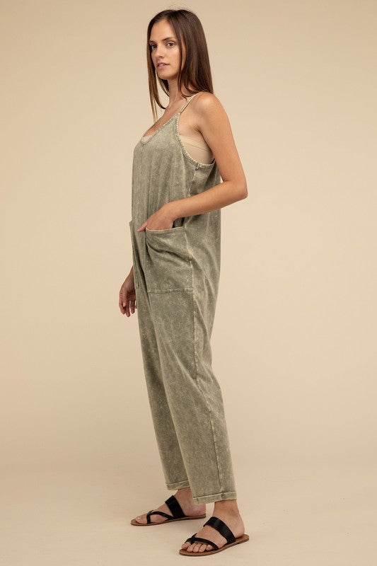 Woman standing and posing in a studio, wearing casual comfort style green Washed Spaghetti Straps Overalls with Pockets and sandals.