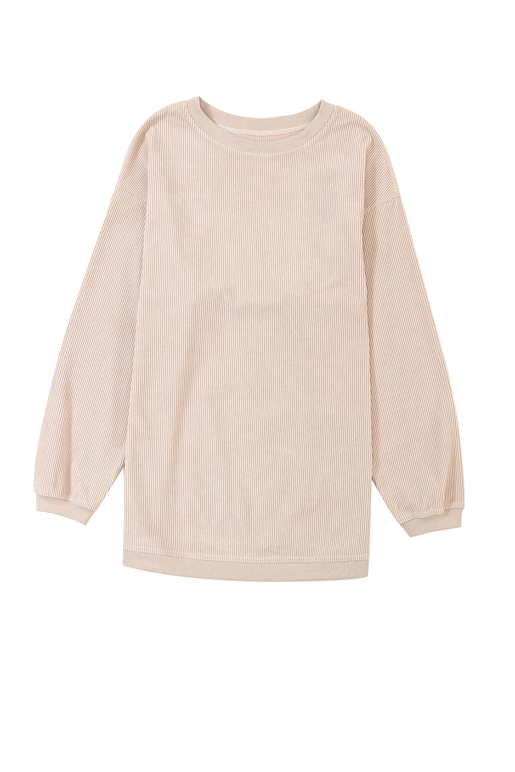 A woman stands outdoors, looking down while touching her hair with one hand. She is wearing an Apricot Ribbed Corduroy Oversized Sweatshirt and white pants, exuding an effortlessly chic and fashionable look.