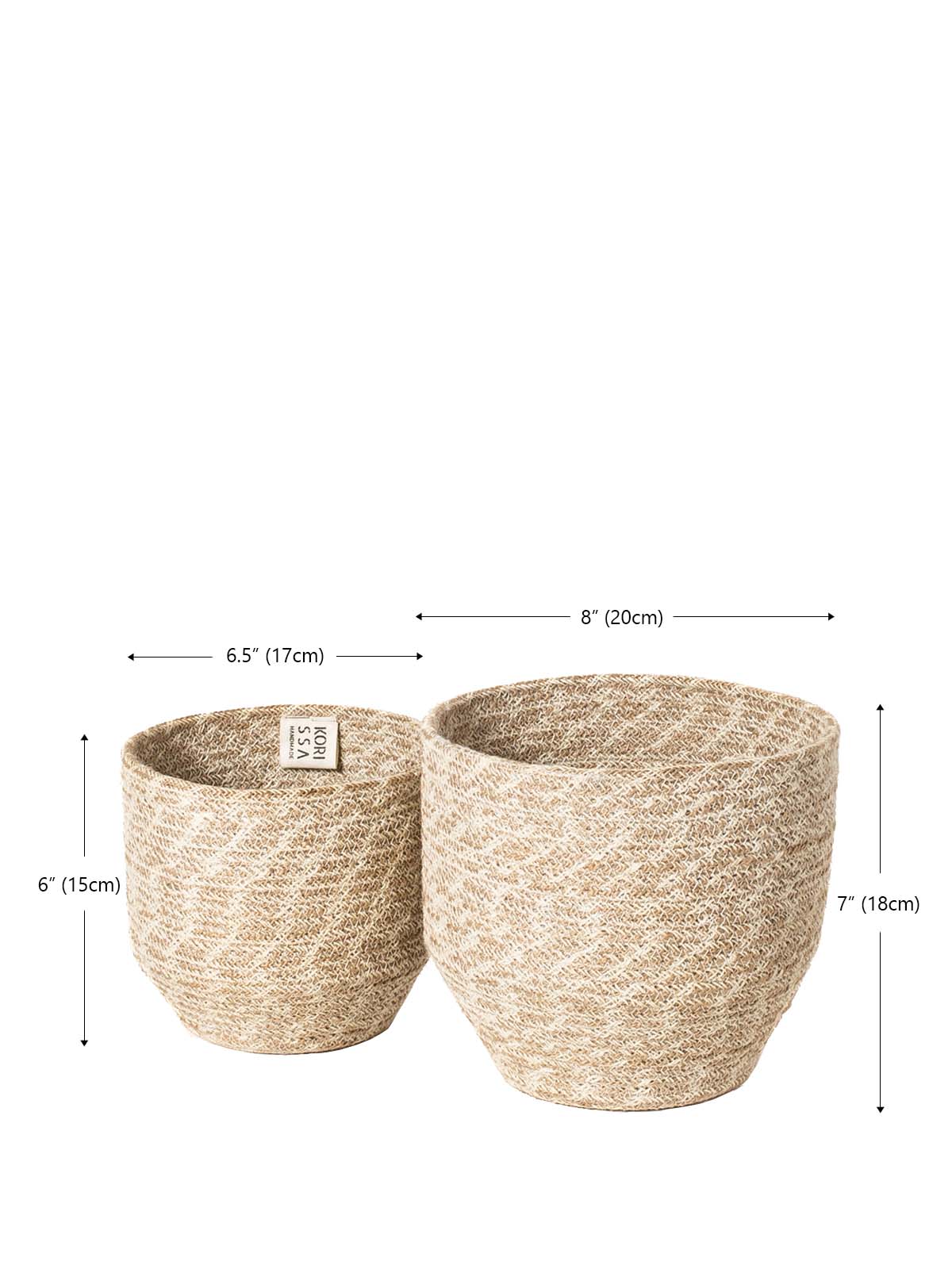 The Agora Bin set includes two woven baskets of different sizes, meticulously handmade from natural fibers. These exquisite pieces are adorned with jute yarn detailing and embody fair trade principles.