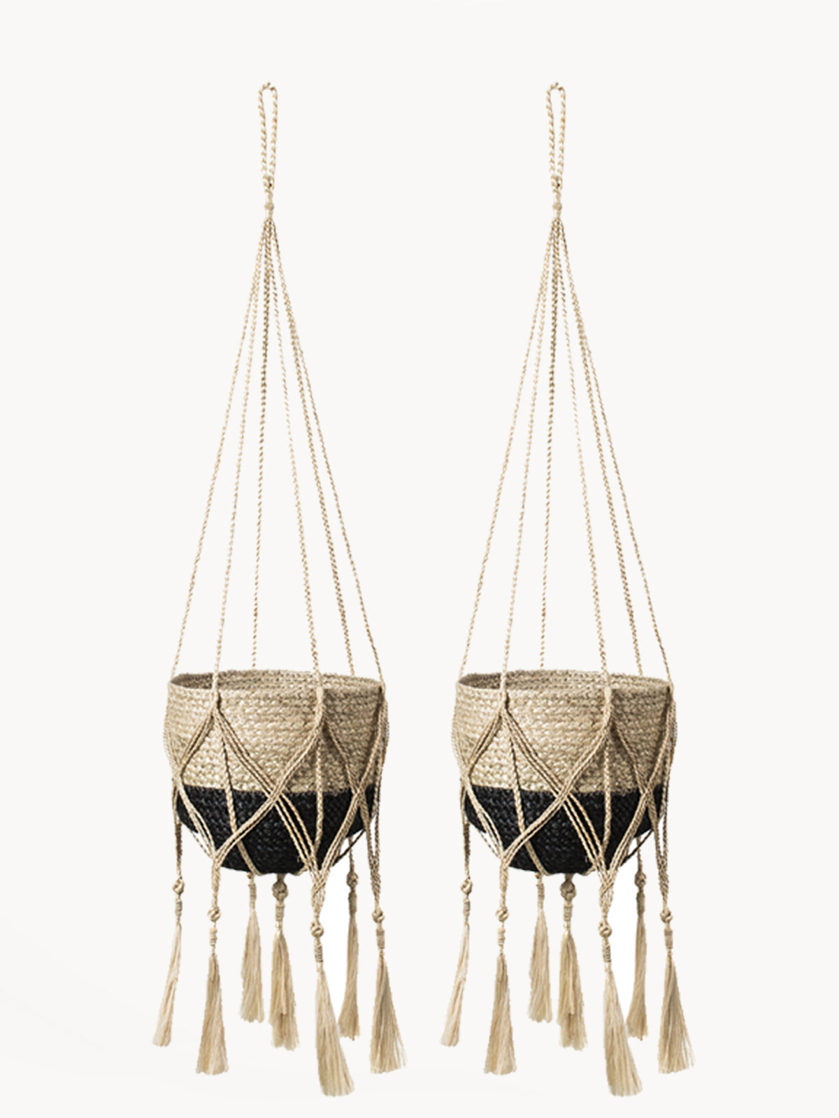 The Plant Hanger - Bitan is a handmade jute hanger crafted by Fair Trade artisans, featuring natural fibers with a striking black base and playful tassels.