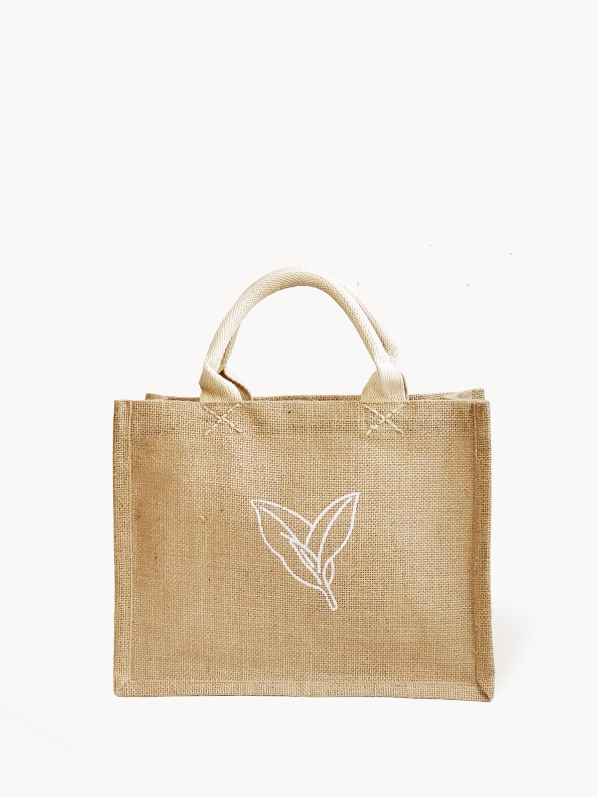 The Gift Bag - Nature is a beige tote made from natural jute, adorned with two handles and a minimalist leaf design on the front.