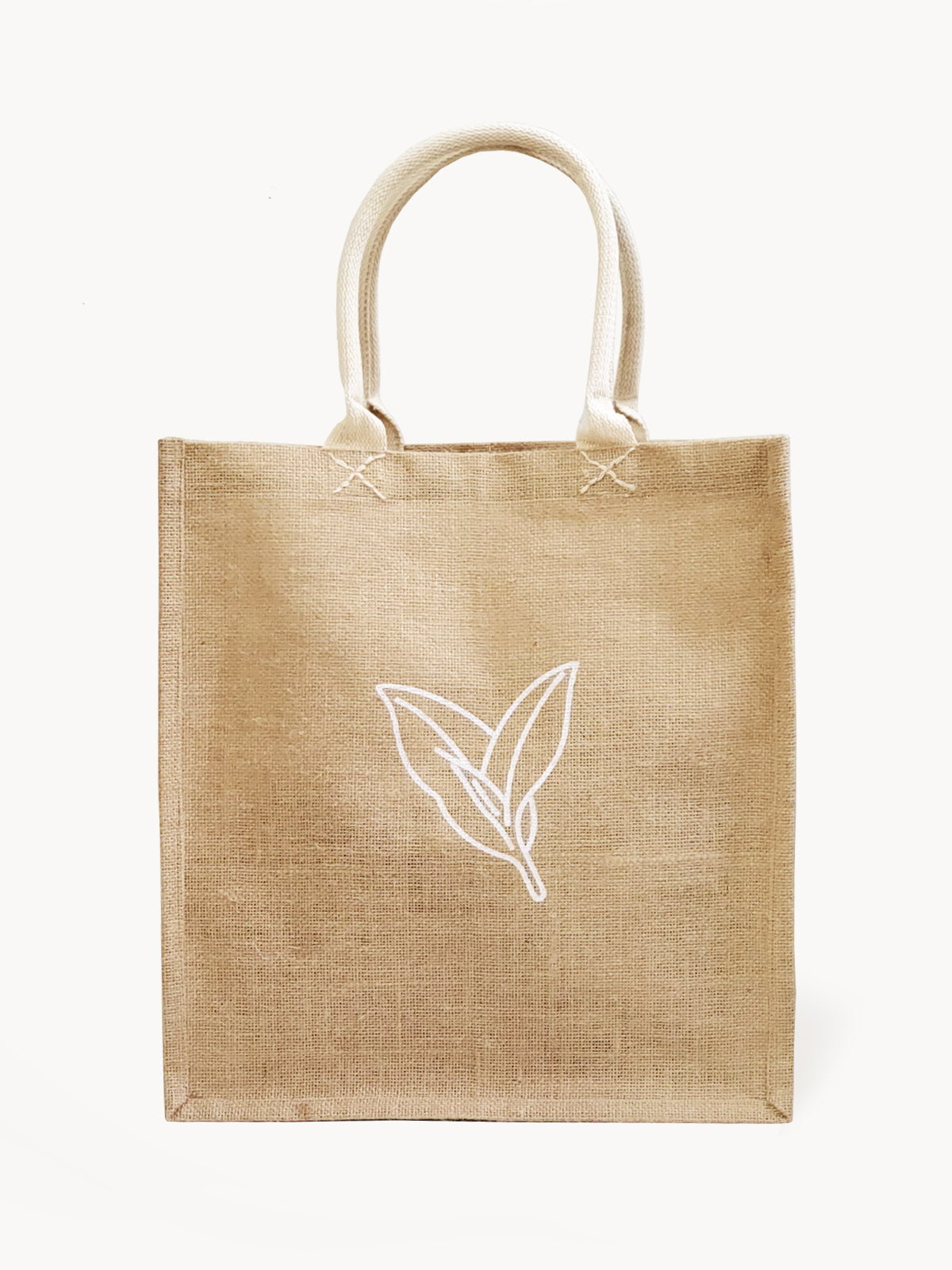 Introducing the Market Bag - Nature: a durable brown jute tote with two handles, adorned with an elegant white leaf design on the front. Handcrafted by Fair Trade artisans, this sustainable and reusable bag is ideal for any outing.