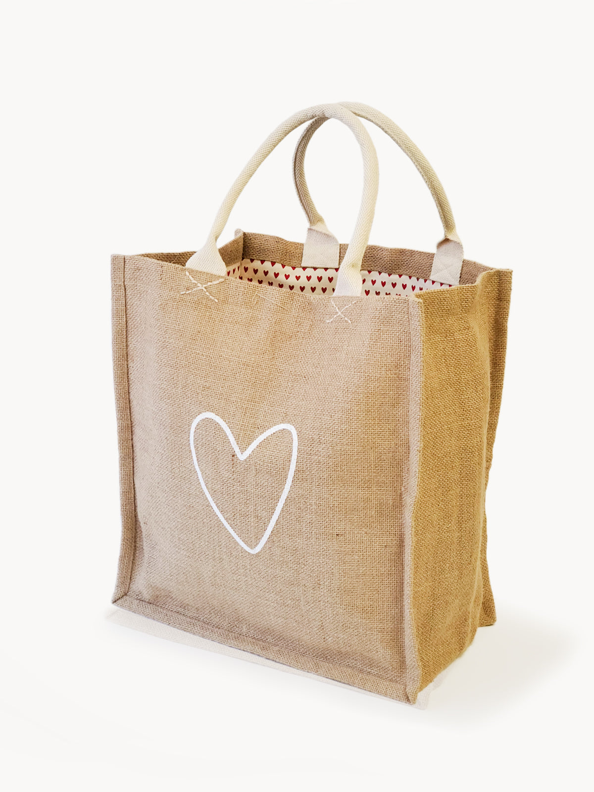 The Jute Canvas Market Bag - Love, featuring a delightful heart design and beige handles, crafted by Fair Trade artisans, is displayed gracefully against a plain background.