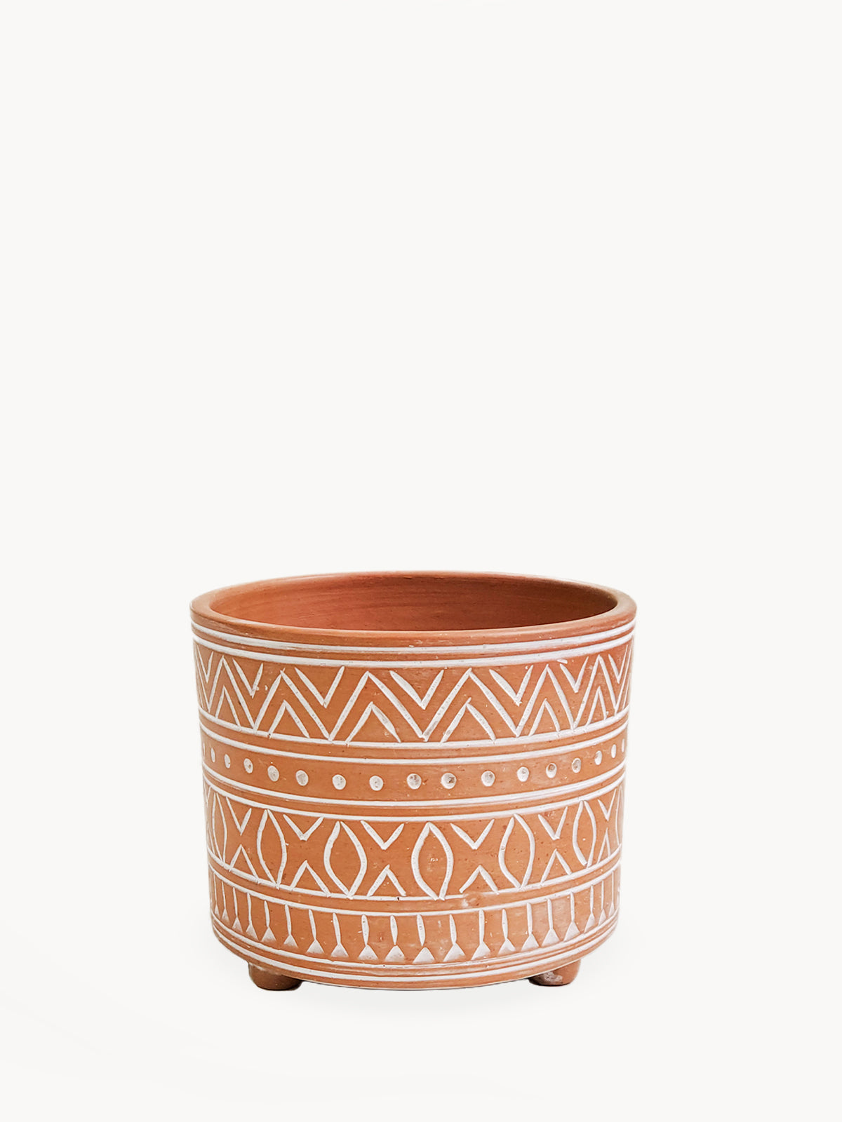 The Hand Etched Terracotta Pot - Small, featuring intricate artisan-inspired white patterns, stands elegantly against a plain background.