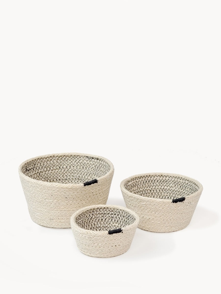 Amari Bowl - Black (Set of 3) features a minimalistic design with three beige woven baskets in different sizes, accented by black bands, crafted by Fair Trade artisans.