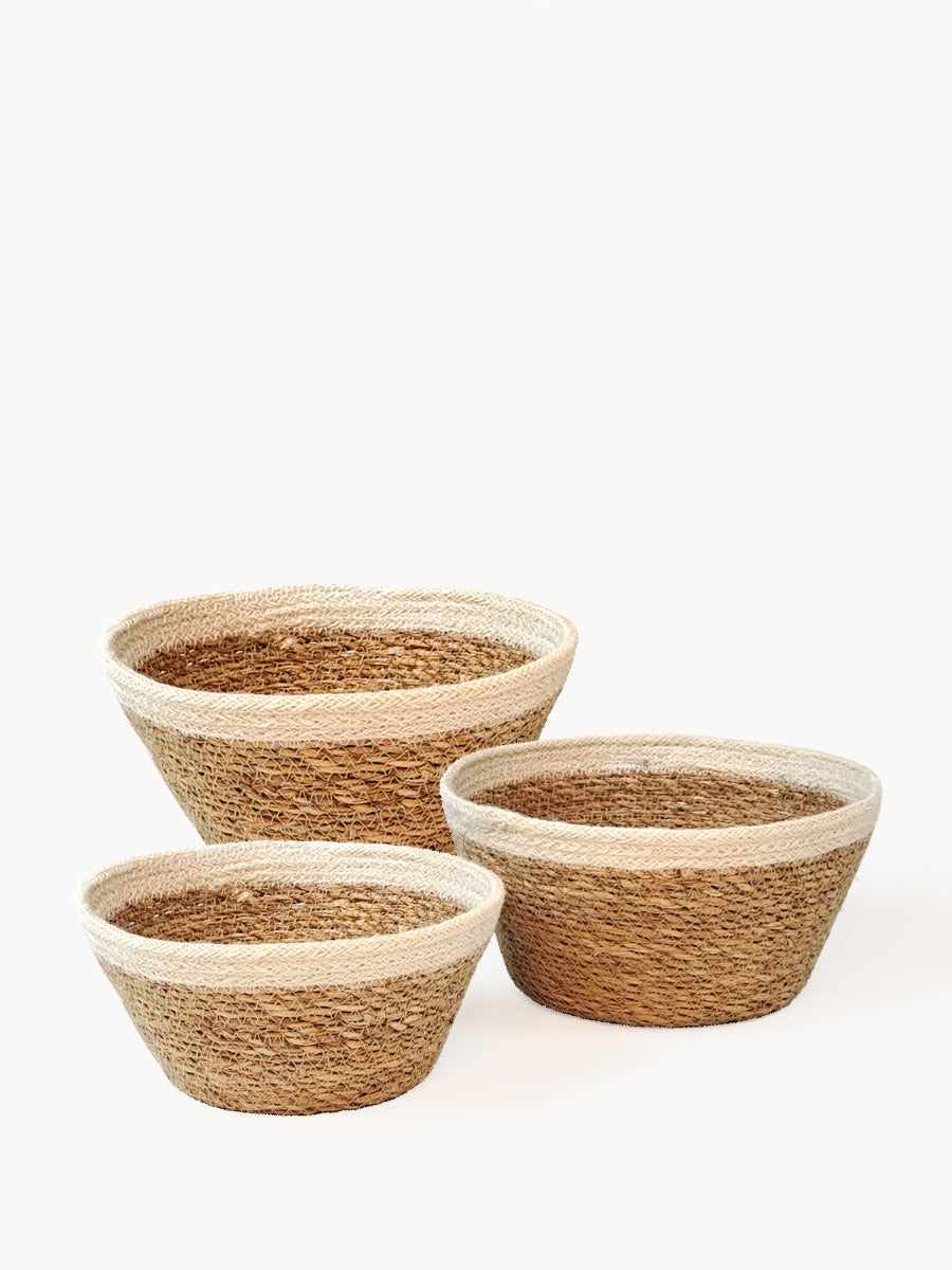 The Savar Plant Bowl Set, featuring three woven bowls of different sizes crafted by Fair Trade artisans, is arranged against a plain background.