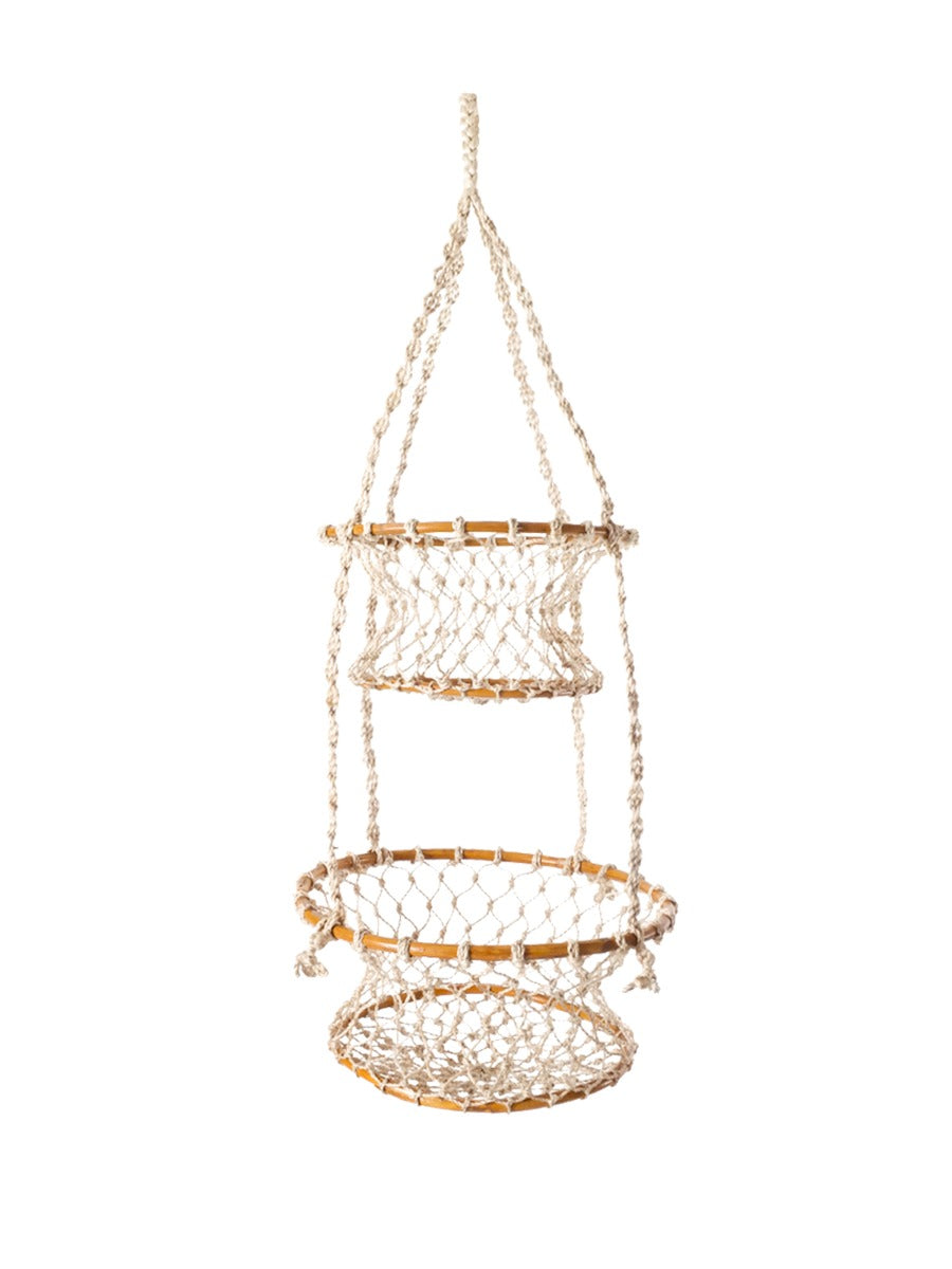 The Jhuri Double Hanging Basket is a macramé plant holder with two intricately woven baskets, each holding a lush green plant. Created by Fair Trade artisans, this piece showcases sustainably handmade craftsmanship and timeless elegance against a simple backdrop.