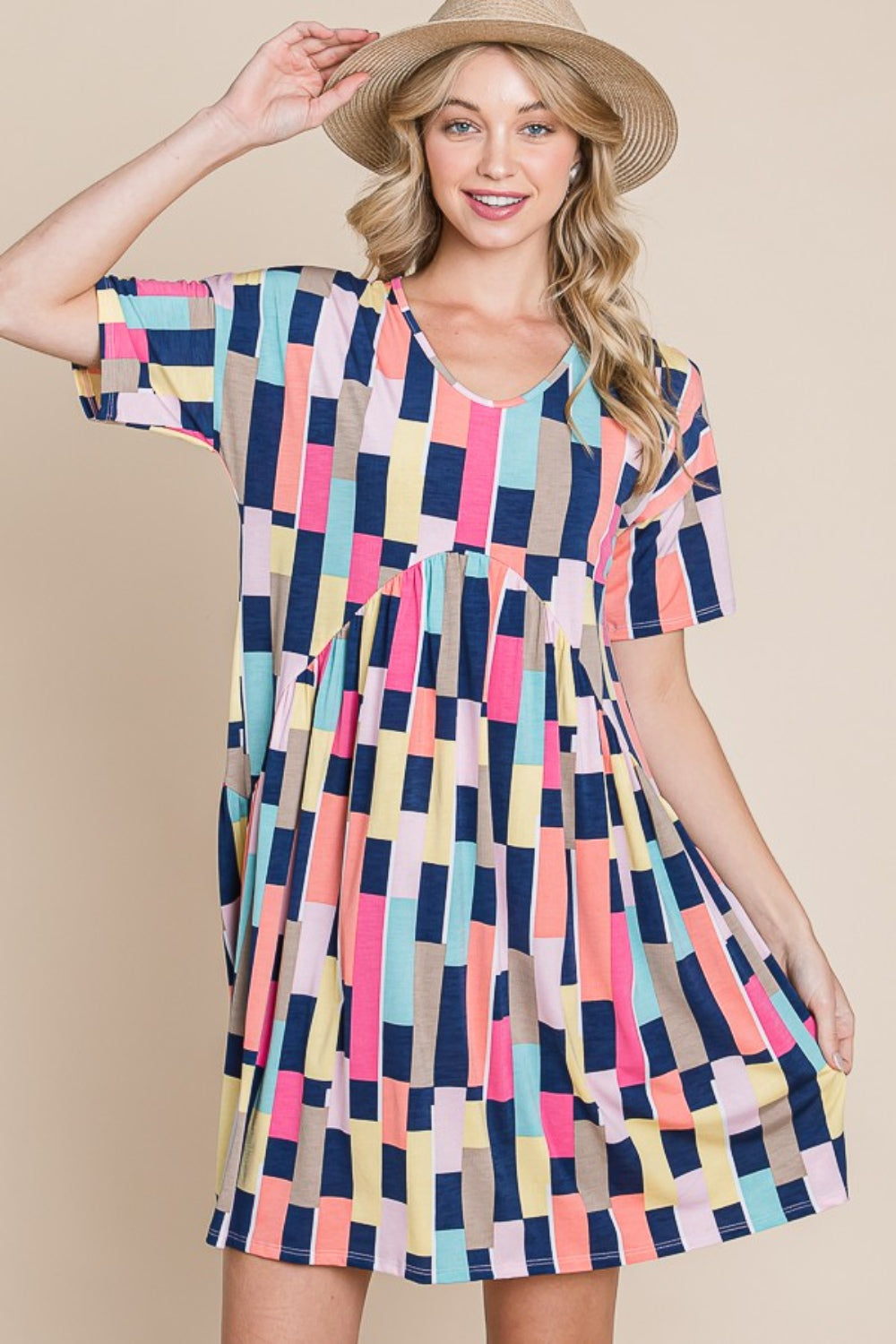 Person wearing the BOMBOM Ruched Color Block Short Sleeve Mini Dress and a straw hat, standing against a beige background, smiling.