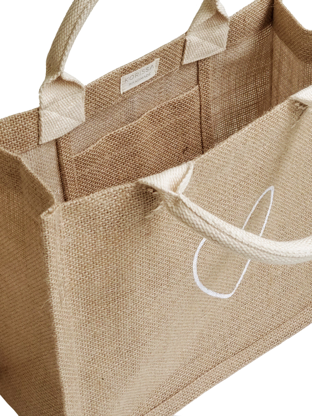 The "Gift Bag - Love" is a beige jute tote bag, handcrafted sustainably with short handles and adorned with a white heart outline on the front.