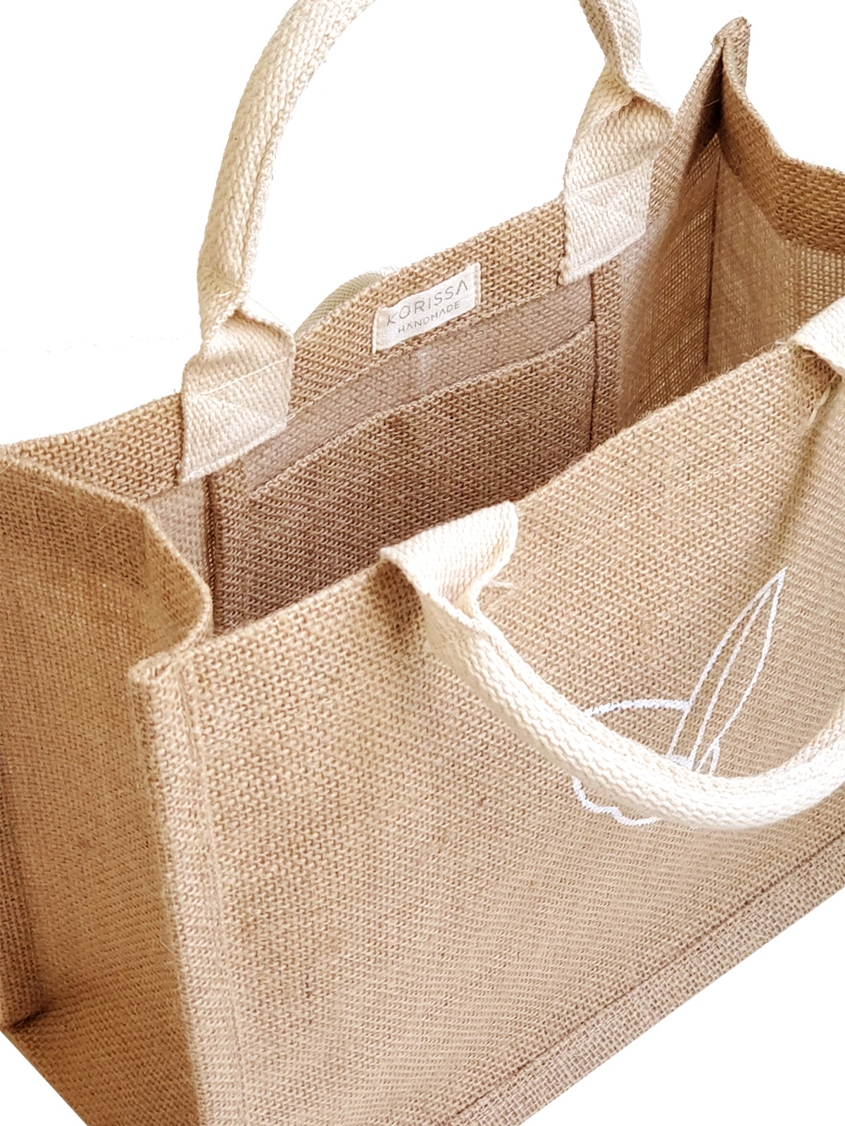 The Gift Bag - Nature is a beige tote made from natural jute, adorned with two handles and a minimalist leaf design on the front.