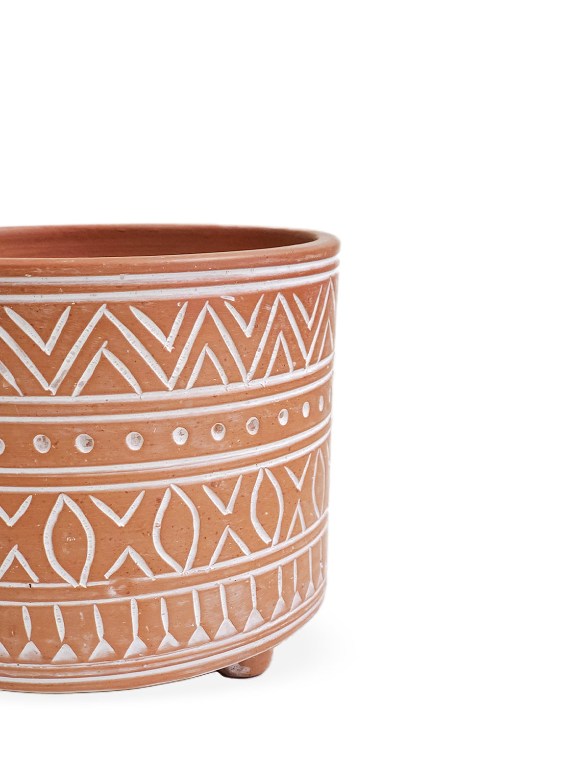 The Hand Etched Terracotta Pot - Small, featuring intricate artisan-inspired white patterns, stands elegantly against a plain background.