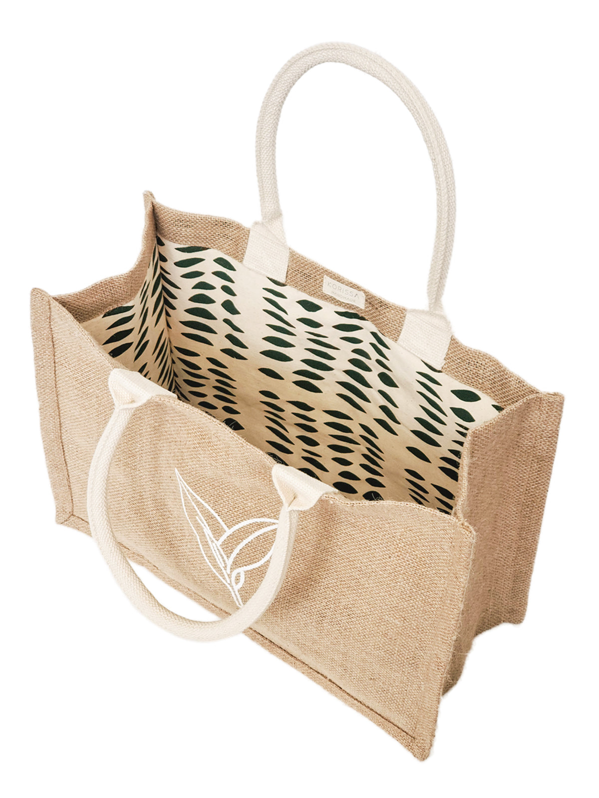 Introducing the Jute Canvas Shopping Bag - Nature: This eco-friendly, rectangular tote bag showcases cream handles and a white leaf design on the front. Carefully crafted by Fair Trade artisans, it boasts a patterned lining featuring black shapes, offering a blend of style and sustainability.