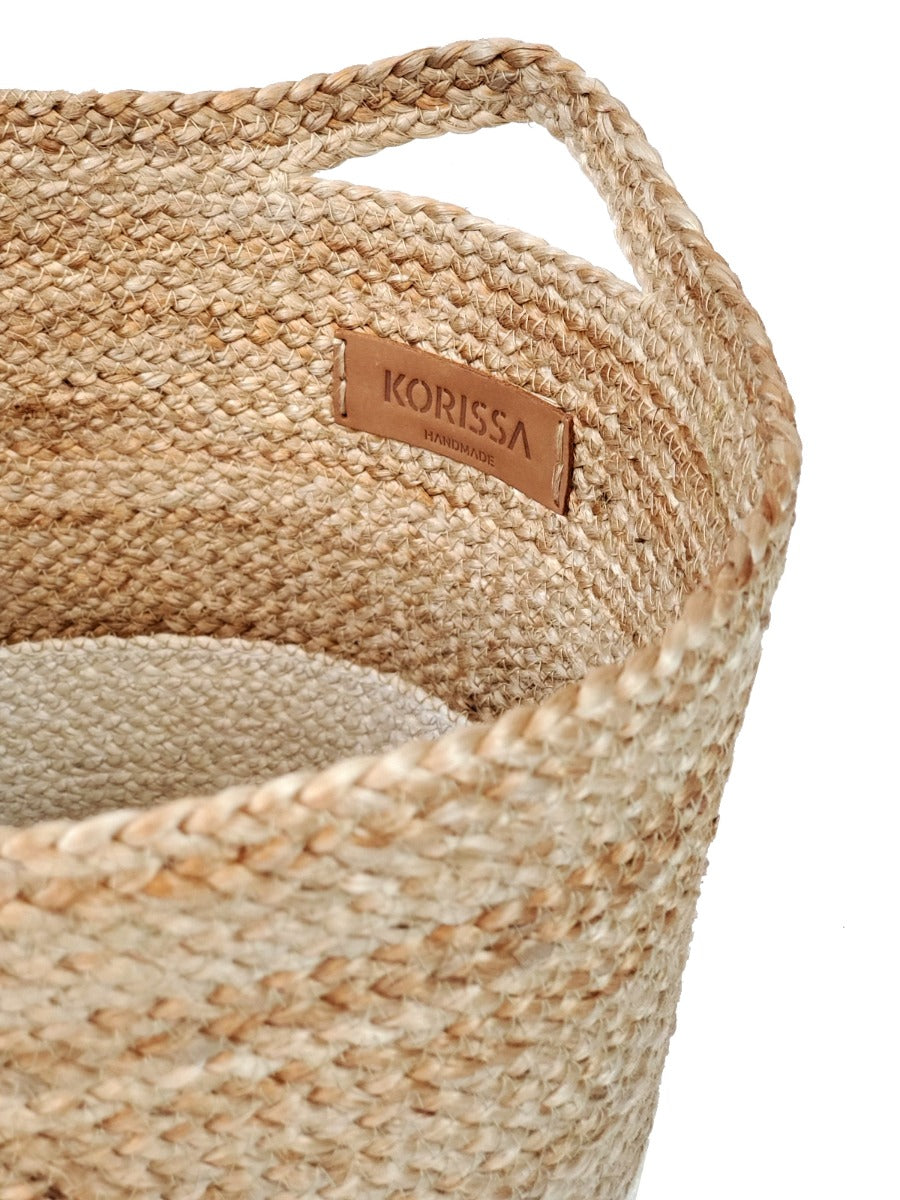 Two Kata Colorblock baskets with handles, featuring a two-tone design in natural and white fibers, crafted by Fair Trade artisans.