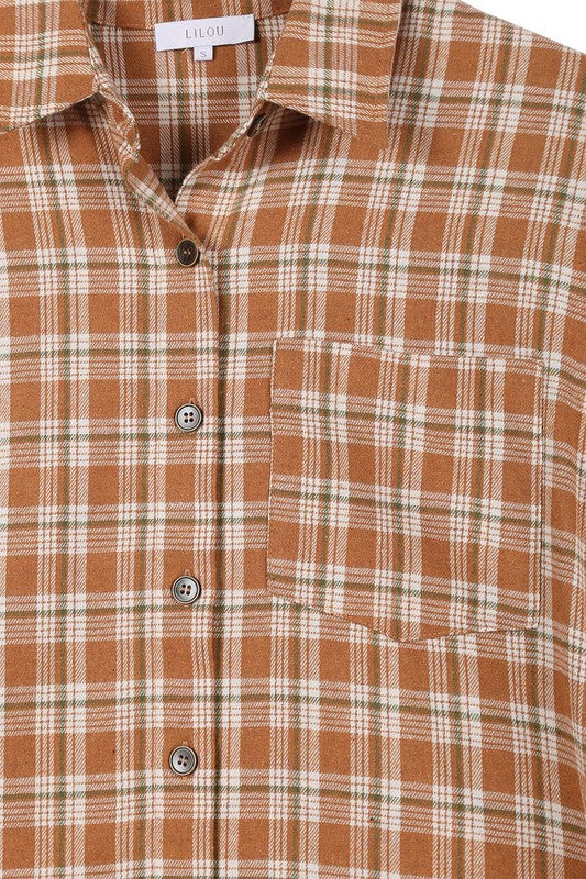 Wearing an Autumn beige plaid shirt, a person with long hair complements their look with hoop earrings, showcasing the season's warm hues. This long-sleeved shirt rests gracefully against a beige backdrop and is ideal for machine wash cold care.