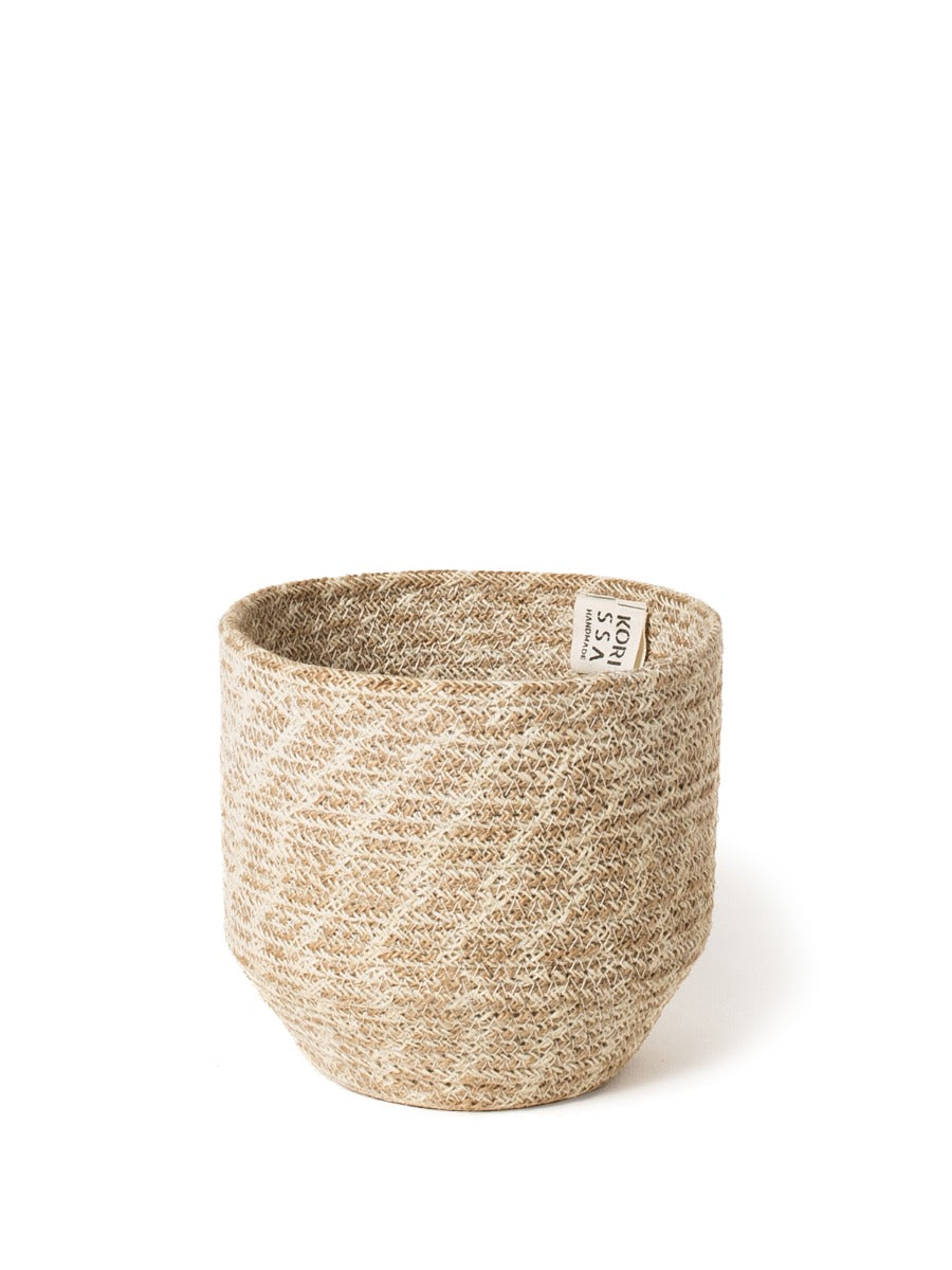 The Agora Bin set includes two woven baskets of different sizes, meticulously handmade from natural fibers. These exquisite pieces are adorned with jute yarn detailing and embody fair trade principles.