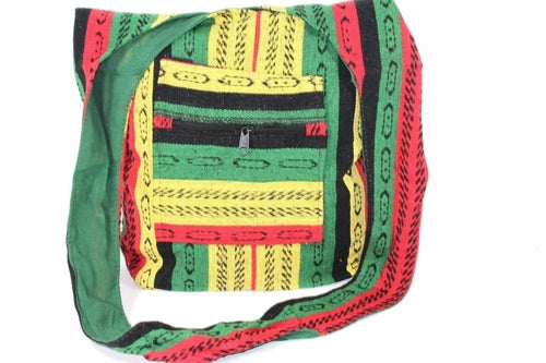 The Rasta Vibes Durrie Sling Bag is a colorful, handcrafted shoulder bag made from 100% cotton with vibrant red, yellow, green, and black stripes. It includes two small front pockets with wooden buttons, embodying traditional Rasta colors.