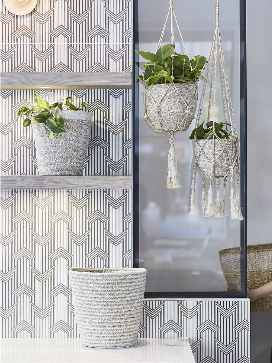 Two Agora Bins, handcrafted woven baskets of varying sizes, made with Fair Trade Jute Yarn, are placed side by side against a plain background.