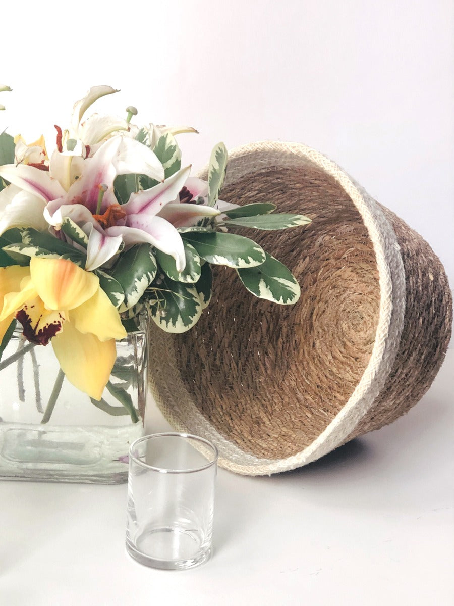 The Savar Plant Bowl Set, featuring three woven bowls of different sizes crafted by Fair Trade artisans, is arranged against a plain background.