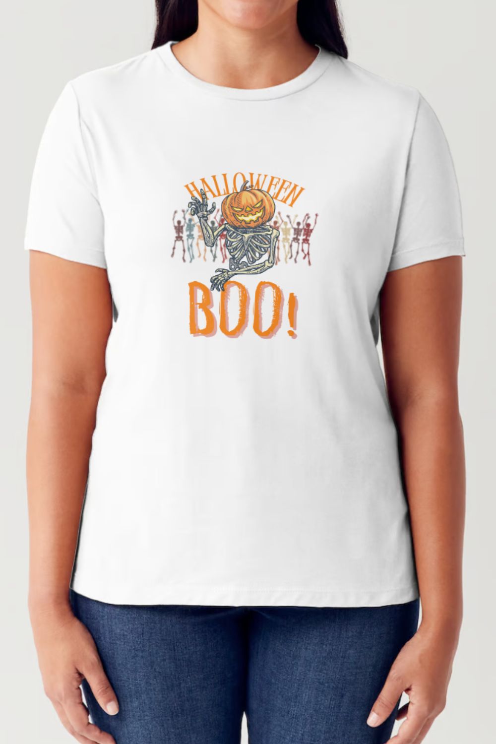 A person wearing a Simply Love Full Size Pumpkin Skeleton Graphic Short Sleeve Tubular T-Shirt, which features a festive Halloween design with a pumpkin, skeletons, and the text "Halloween BOO!".