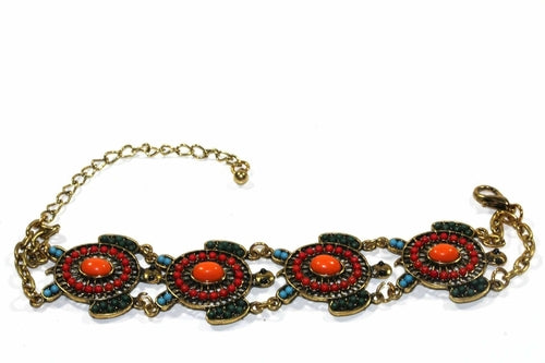 The Colorful Bead Drop Turtle Bracelet is a handmade piece featuring red and orange stones in circular patterns on a gold chain with clasp, boasting an antique style finish that adds timeless elegance to any collection.