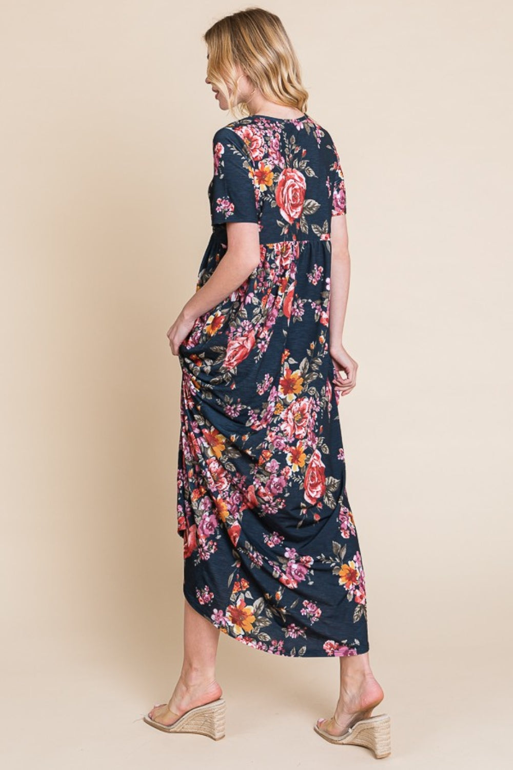 A person wearing the elegant BOMBOM Floral Short Sleeve Maxi Dress, featuring a long and flowy silhouette, stands against a plain background.