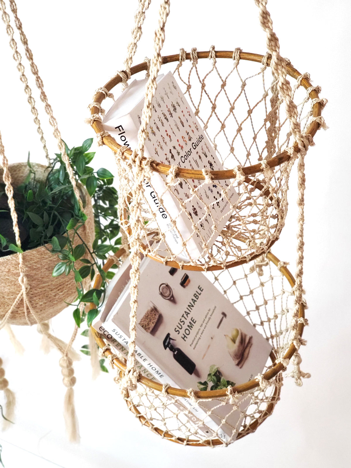 The Jhuri Double Hanging Basket is a macramé plant holder with two intricately woven baskets, each holding a lush green plant. Created by Fair Trade artisans, this piece showcases sustainably handmade craftsmanship and timeless elegance against a simple backdrop.