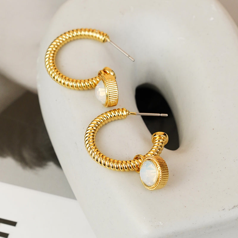 Introducing the Rope Cat's Eye Stone C-Hoop Earrings, featuring a gold-plated coiled design adorned with cat's eye gemstones near the clasps, set against a plain white background.