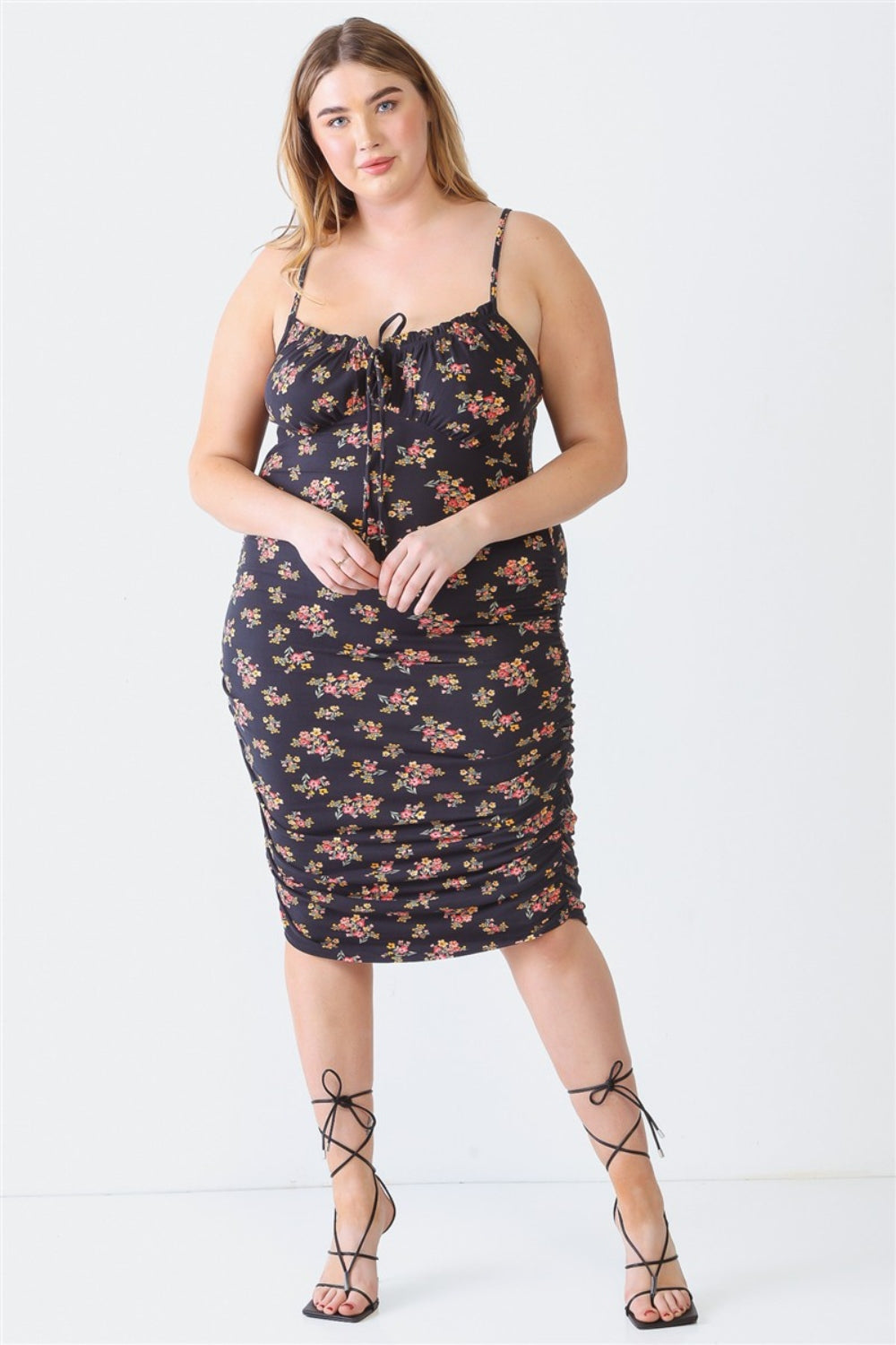 A woman stands against a white background wearing a Blue Leopard Plus Size Ruched Floral Square Neck Cami Dress with strappy high-heeled sandals, perfect for a summer day out.