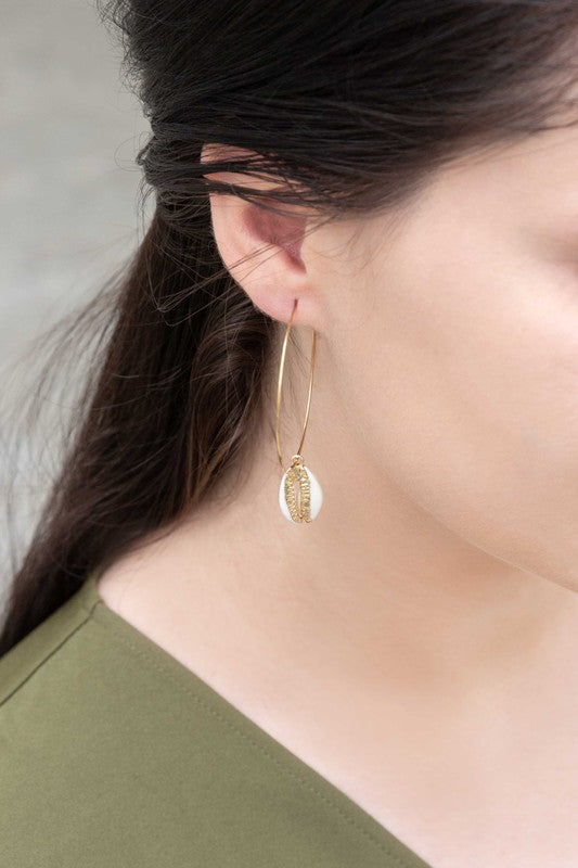 By the Shore Hoop Earrings - 14K hoop earrings with sea shell charm on a white background.