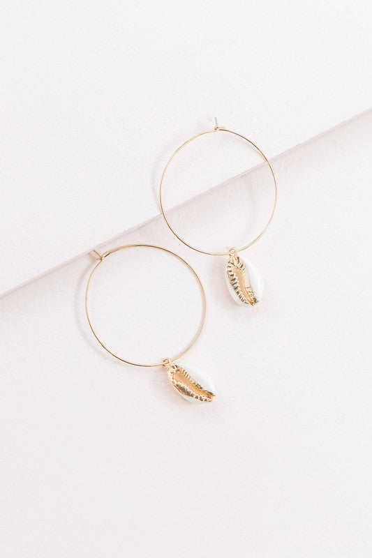 By the Shore Hoop Earrings - 14K hoop earrings with sea shell charm on a white background.