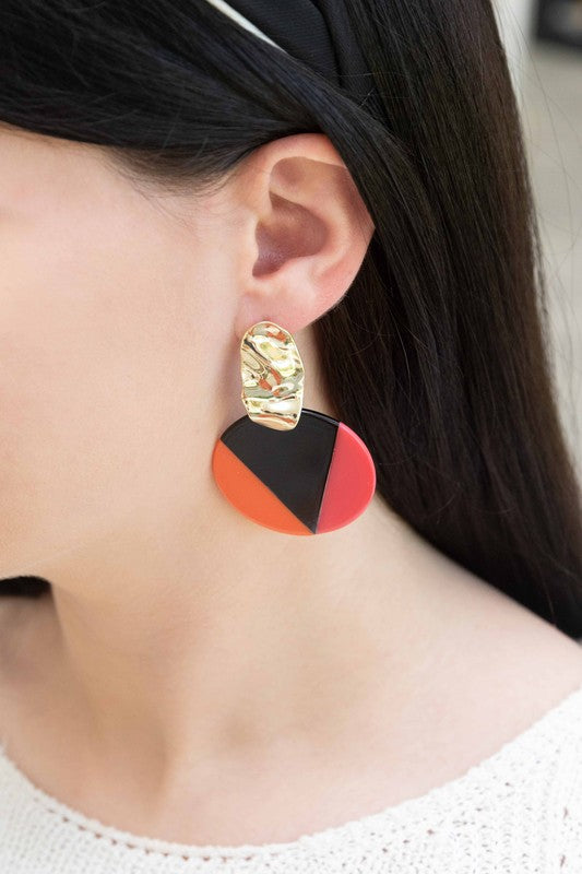 A pair of Color Block Drop Earrings with gold-tone hardware and geometric black and teal design.