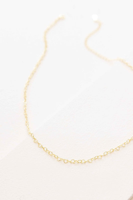 A delicate Chain of Hearts Necklace in 18K Gold over Sterling Silver on a white surface.