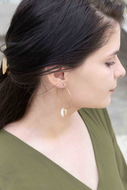 By the Shore Hoop Earrings - 14K hoop earrings with sea shell charm on a white background.