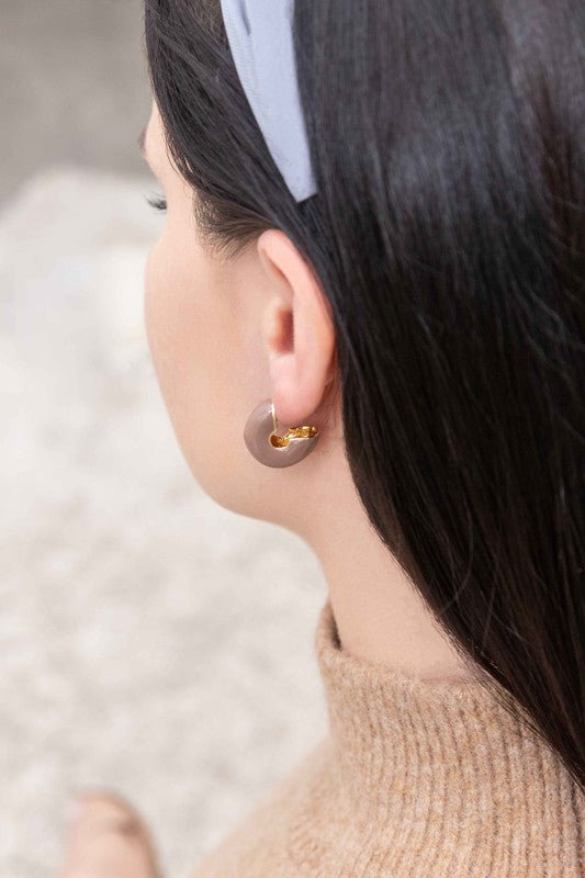 A pair of Thick Mini Hoop Earrings displayed on a white background.