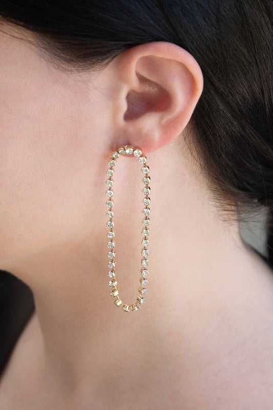 A pair of Can't Get Enough Drop Earrings with embedded crystals on a light background.