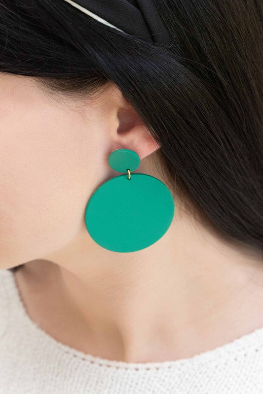 A pair of En Vogue Dangle Earrings in teal color against a white background.
