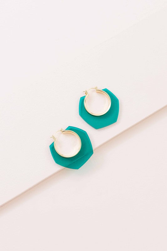 A pair of Angled Clear Hoop Earrings displayed on a white surface.